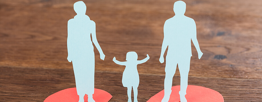 Child Support - paper images of an adult female and an adult male with a child in between them reaching for each adult's hand.